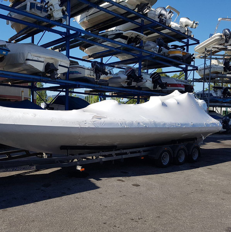 Shrink wrapped boat in boat transport yard